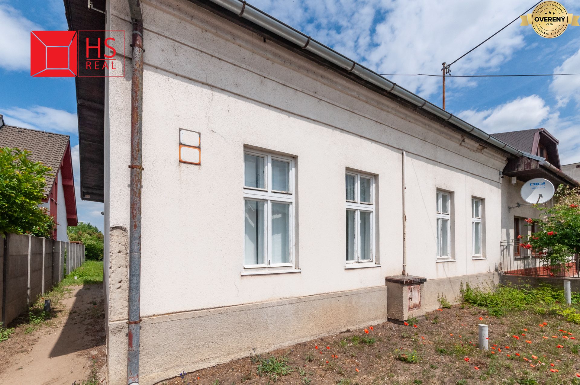 Rodinný dom na Dojstojevského ulici v Nových Zámkoch s bielou fasádou a satelitom.